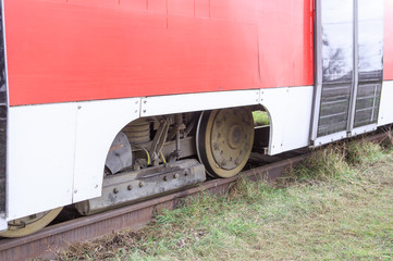 Wheels of a red tram on rails