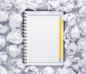 White note pad on white background. Around the notepads lies lot crumpled paper,Copy space