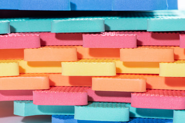 Macro photo of the details of a foam. Colored rubber mat puzzle for children.