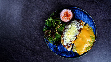A nice breakfast plate with cheddar cheese, onion and tomato sauce