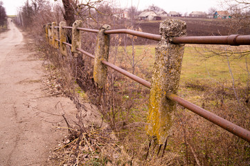Destroyed reinforced concrete handrails. The destroyed old bridge. Old bridge in the village.
