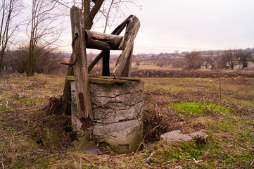 Old, abandoned and destroyed well. Abandoned source in the village.