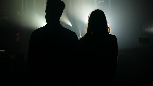 Couple in front of concert lights during rehearsal
