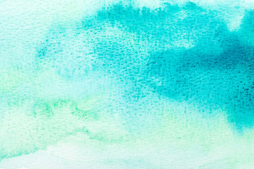 Abstract blue watercolor background. The color splashing on the paper. Hand drawn.