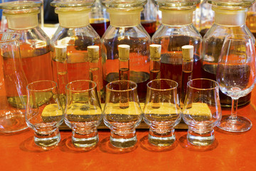 Whisky tasting setup with numbered sampling glasses, beaker and bottles on display