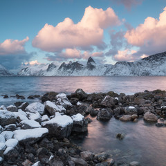 An idyllic landscape with snow and the sun in Norway Dramatic, but beautiful sunset within the amazing winter landscape of the Lofoten Islands taken in February. Landscape nature concept