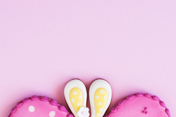  Polka dot easter egg and bunny ear cookies on a pink background.
