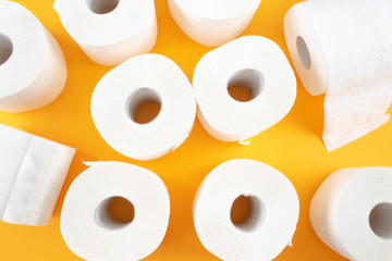 top view of toilet paper rolls on orange background