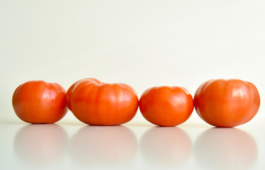 red ripe tomatoes on a white background