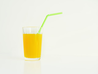 glass with yellow juice on a white background