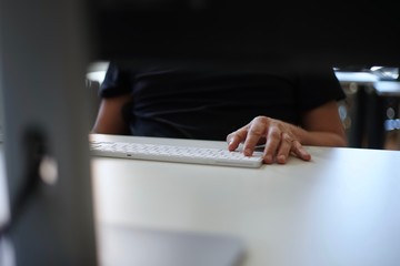 Close up of male hands typing with keyboard    