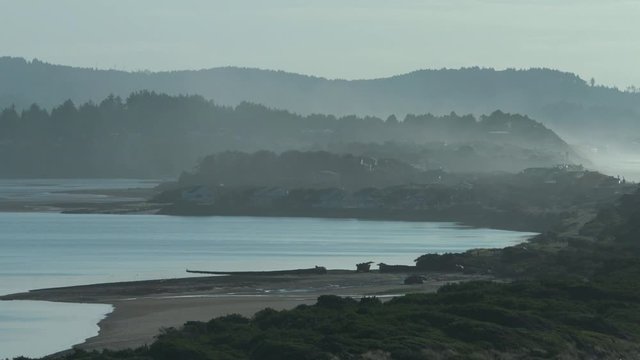 Panning shot from lagoon across spur to coast