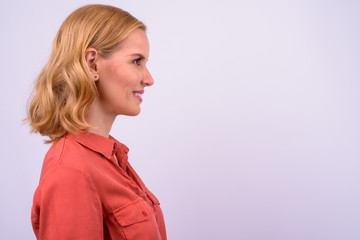 Closeup profile view of happy beautiful blonde businesswoman smiling