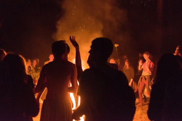 Fototapeta na wymiar Kiev, Ukraine, - June 03, 2018: A lot of people around the fire at night at the festival.