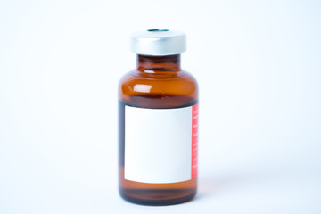 Brown glass bottle with label on white