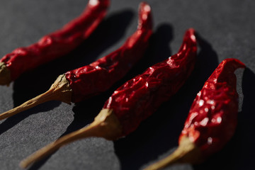 red hot chili peppers laying on a black surface. Perfect for reatauraints or food and cooking...