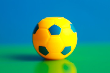 Obraz premium smalll toy ball on a green and blue background