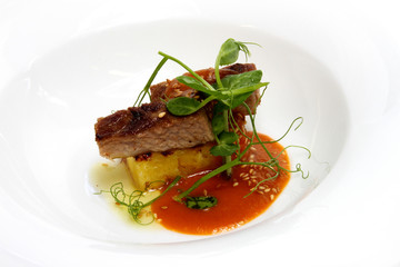 Browned Secreto de Bellota with grilled pineapple, pea sprouts and pineapple barbeque sauce