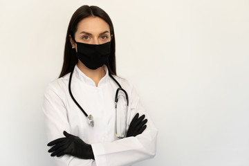 Female doctor in black protective medical mask and black gloves, a stethoscope on neck