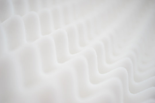 White gradient abstract background with many waves at different angles.