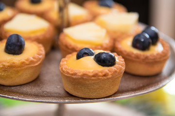 Close up of fruit tarts with blueberry and pineapple 