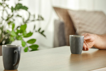 Desk of free space and blurred interior with window and man hands 