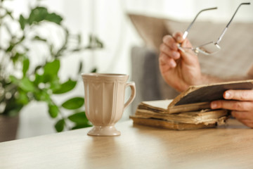 Desk of free space and blurred interior with window and man hands 