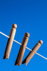 Wooden clothes pegs on a washing line