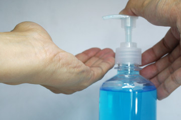 Cleansing hands with hand sanitizer gel with alcohol 70% . Hand push bottle for handrubs .Protect against viruses and bacteria Concept. ( Covid-19 or Coronas Virus )