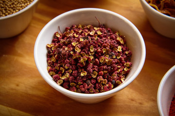 Sichuan / Szechuan pepper in white bowl on wooden background