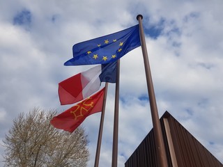 american flag waving in the wind in front of blue sky