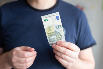 5 euro banknote. Man Hand holding cash paper money.Financial and money concept. job seeker....