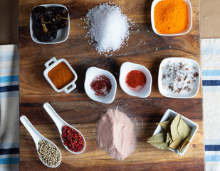 Spanish spices and herbs on wooden background.
