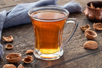 A cup of herbal tea made from walnut shells - folk remedy for coughing