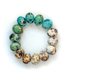 Easter card with quail eggs of beige color and colored with natural dyes in blue. Traditional Easter background, isolation with painted eggs