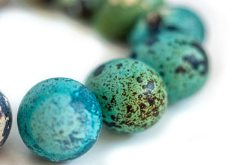 Easter card with quail eggs colored with natural dyes in blue. Traditional Easter background, isolation with painted eggs