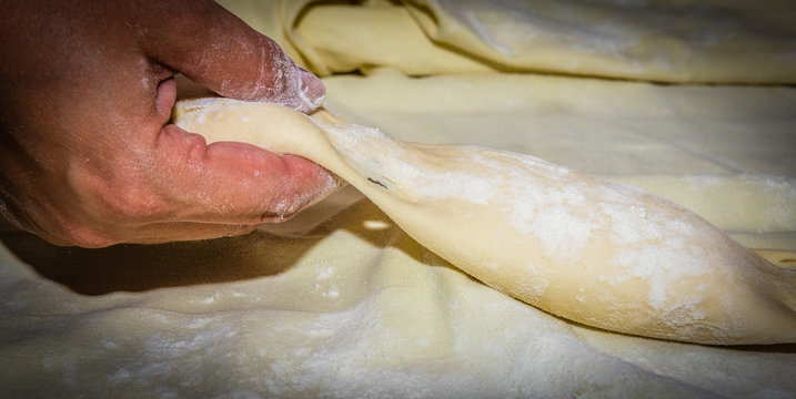 Making of small strukels using hand. It closes the dough so the cotage cheese cannot escape while coocking.