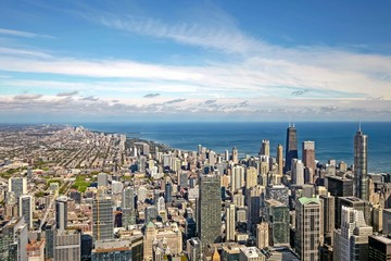 View of downtown Chicago on a blue sky sunny day with wispy white clouds.