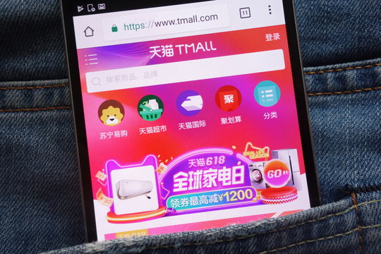 KONSKIE, POLAND - JUNE 02, 2018: TMall website displayed on smartphone hidden in jeans pocket
