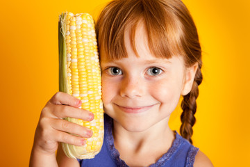 Happy Little Girl Holding Corn on the Cob, Healthy Eating, Food, Nutrition
