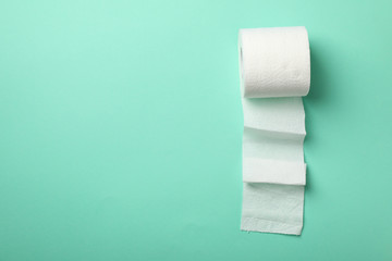 Toilet paper on mint background, space for text