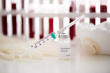 Test tubes with blood sample Covid-19 coronavirus. Vaccine and syringe injection It use for...