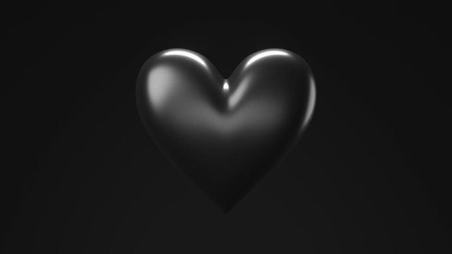 Black broken heart objects in black background. Heart shape object shattered into pieces.