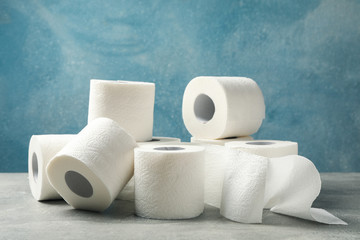 Toilet paper on grey table, space for text