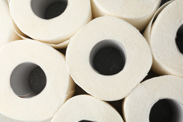 Rolls of toilet paper on whole background, top view