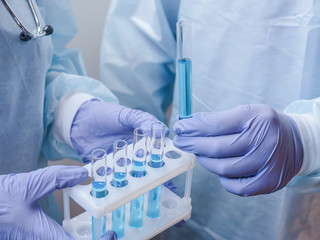 Two medical scientists hadling test tubes