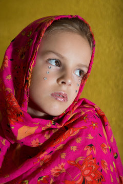 Little Girl Wrapped In A Shawl And With Dramatic Make-up