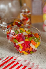 An old fashioned glass jar of delicious jelly beans, with another out of focus jar of sweets in the background