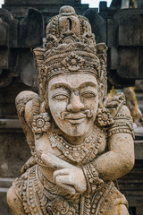 Fototapeta na wymiar A close up on a guardian figure next to Pura Tirta Empul temple on Bali. Traditional and historical site. Sculpture of a Balinese temple guardian