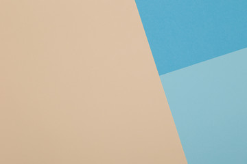 Blue and yellow background, colored paper geometrically divides into zones, frame, copy, space.